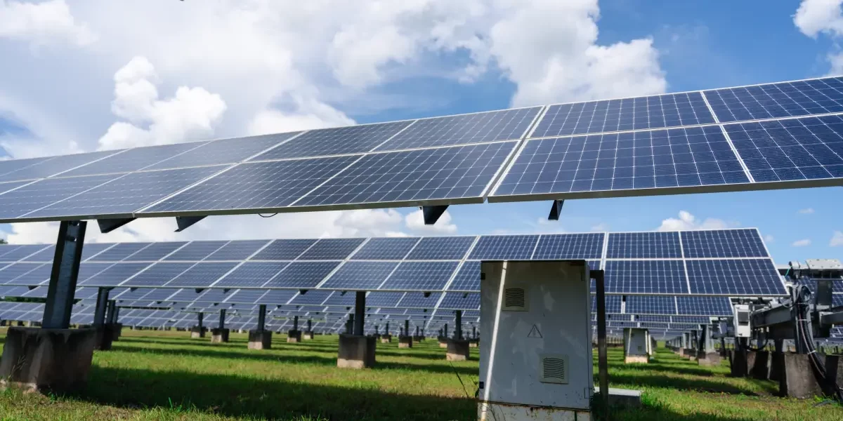 Rows of large solar panel arrays installed on open land illustrate the difference between residential and commercial solar systems in Bluffdale.