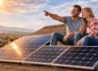 Couple on rooftop with solar panels installed on a residential home during sunset.
